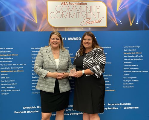 Christina Bradley, Asst. Vice President of Marketing and Christie Cox, Vice President of Marquette Bank Neighborhood Commitment accept award from ABA for Volunteerism.